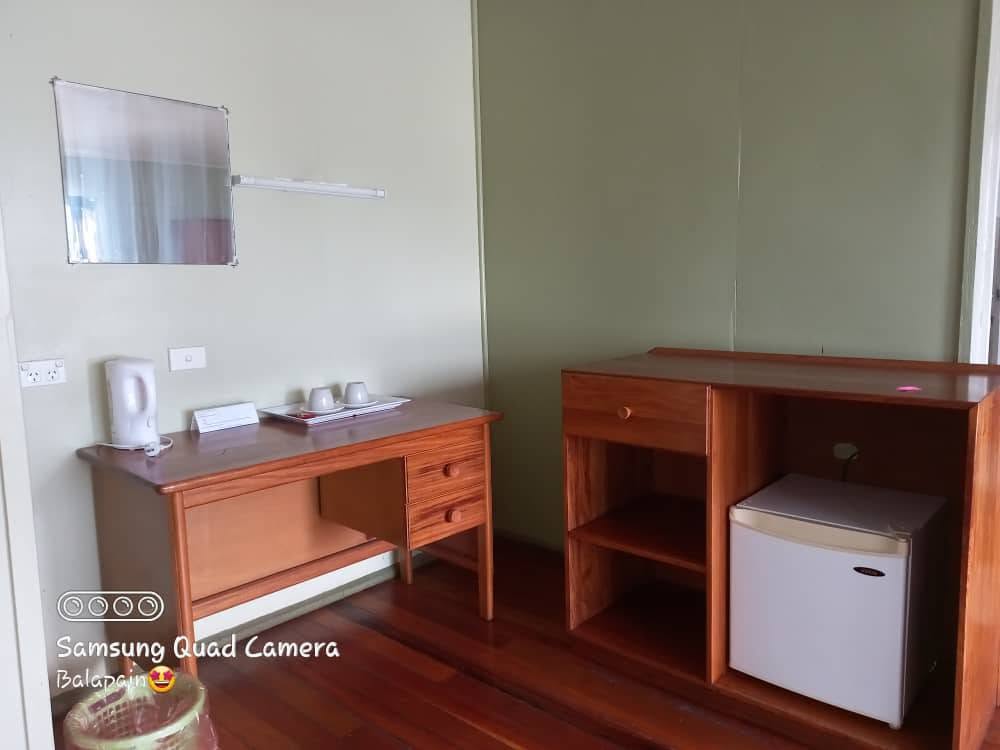Room desk and mini-fridge at Mavra Lodge